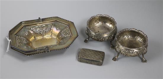 A 19th century silver snuff box, a pair of George III silver bun salts and a later silver sweetmeat basket.